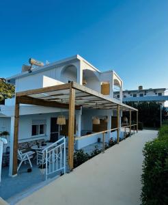 a view of a house with a covered patio at ANGELOS STUDIOS 1-2 Ground Floor in Faliraki