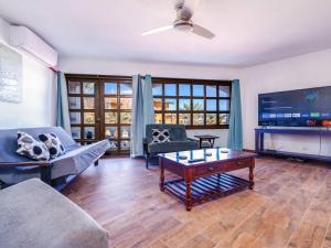a living room with couches and a flat screen tv at La Hacienda San Felipe Rental Condo 2 in San Felipe