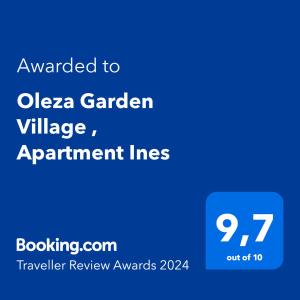 弗拉門戈海灘的住宿－Oleza Garden Village , Apartment Ines，蓝色标志,上面写着被授予oza花园村公寓的字条