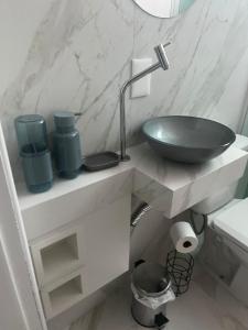 a bathroom with a bowl sink on a counter at Apto 1 dorm - San Francisco - localização perfeita in Balneário Camboriú +23 photos