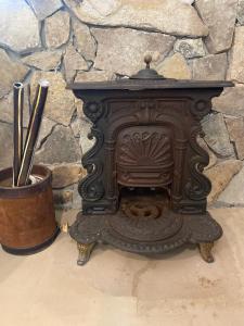 an old wood stove in front of a stone wall at Casa de Campo en LA GUAPEADA POLO, Pilar in Pilar