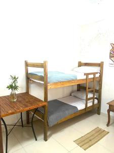 a bunk bed with a table and a desk at Hostel Niterói in Niterói