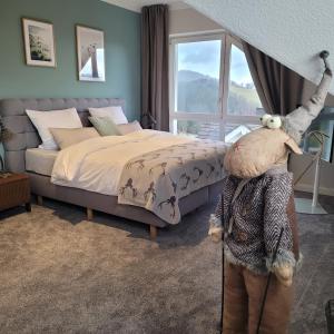 a bedroom with a bed and a large window at Skyline Luxus Suite Willingen in Willingen