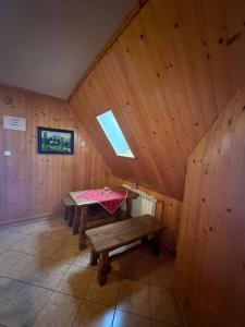 an attic room with a table and a window at Murań in Czarna Góra