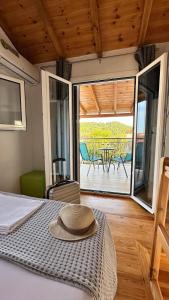 a bedroom with a bed with a hat on it at Del Sol Suites in Skiathos