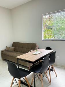 a table and chairs in a living room with a couch at Casas Do Serrano 01 - Lençóis in Lençóis