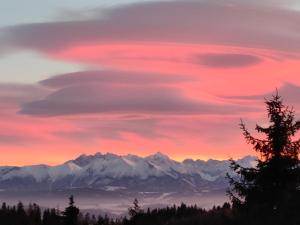 a lenticular cloud formation over the mountains at sunset at Domek w Gorcach in Ochotnica Górna