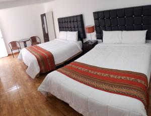 Postel nebo postele na pokoji v ubytování Cusco de mis Sueños Hostal - II