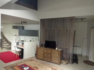 a living room with a television on a wooden cabinet at Ioa Loft in Ioannina