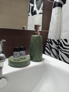 a bathroom sink with a bottle of mouthwash and a soap at Ioa Loft in Ioannina