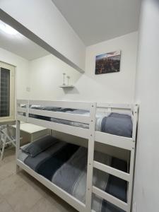 two bunk beds in a room with a desk at Monti Exclusive Apartment in Rome