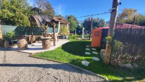 a garden with a fence and a gazebo at La Yourte in Vinassan +9 photos
