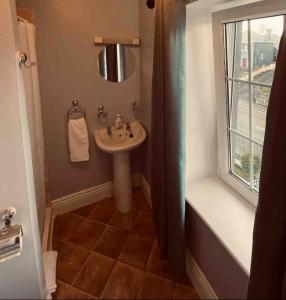 a bathroom with a sink and a window at Beautiful House In Town in Killarney