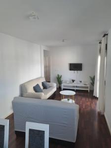 a living room with a couch and a table at Atico TERRAZA DEL CARMEN in Salobreña +26 photos
