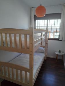 two bunk beds in a room with a window at Atico TERRAZA DEL CARMEN in Salobreña