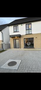 a building with a man hole in the middle of a driveway at Home in Kilmuckridge in Wexford