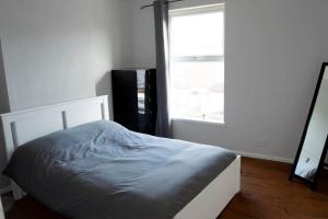 a bed sitting in a room with a window at Heartlands House, BullRing, Blues Ground, NEC, BHX in Birmingham