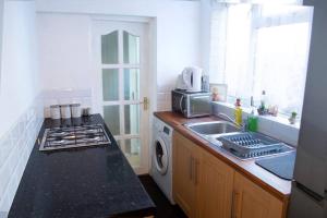 a kitchen with a sink and a stove at Heartlands House, BullRing, Blues Ground, NEC, BHX in Birmingham