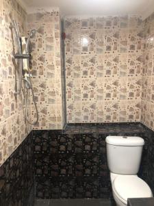 a bathroom with a shower with a toilet in it at Express Hotel in Nilai