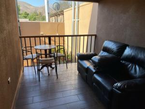 a living room with a couch and a table on a balcony at Hostal doña irene in Vicuña