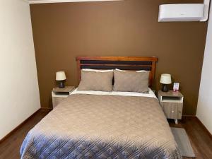 a bedroom with a large bed with two night stands at Hostal doña irene in Vicuña