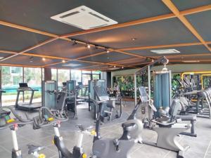 a gym with treadmills and elliptical machines at Cubic Botanical Studio 情侣体验民宿电影院的浪漫 in Kuala Lumpur