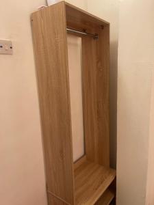 a wooden closet with a mirror in a room at Mph mini in Lagos