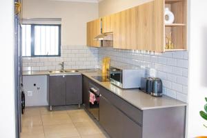 a kitchen with a sink and a counter top at 16 Elizabeth Place - Luxury Apartments, Free Wi-Fi in Midrand