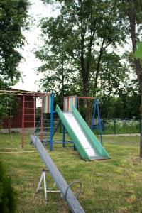 a playground with a slide in a park at Готельно-ресторанний комплекс Фамілія in Bushtyno