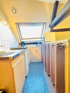 a kitchen with white appliances and a window at La belle époque in Laon