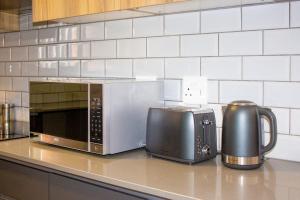 a microwave sitting on a counter in a kitchen at 16 Elizabeth Place - Luxury Apartments, Free Wi-Fi in Midrand