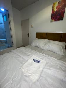 a white bed with a towel on top of it at Mph 4 in Lagos