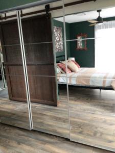 a bedroom with a bunk bed with glass doors at Beautifully Elevated Treehouse Apartment in Buderim