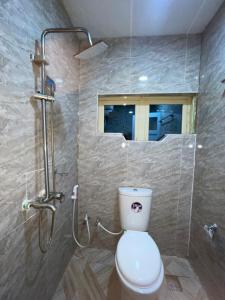 a bathroom with a toilet and a shower with a window at Mph 4 in Lagos