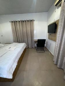 a bedroom with a bed and a desk and a television at Mph 4 in Lagos