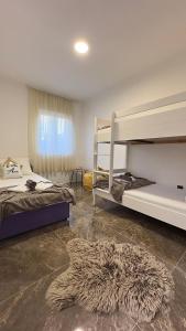 a bedroom with two bunk beds and a furry rug at Villa Ana in Kastel Sucurac