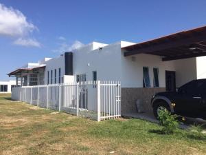 a black truck parked in front of a white house at MM NAPA VILLAGE in Río Hato