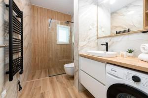 a bathroom with a sink and a washing machine at Diva Apartment Dubrovnik in Dubrovnik +13 photos