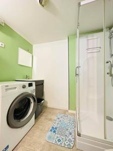 a bathroom with a washing machine and a shower at Le Havre de Paix in Laon