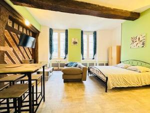a bedroom with a bed and a dining room at Le Havre de Paix in Laon