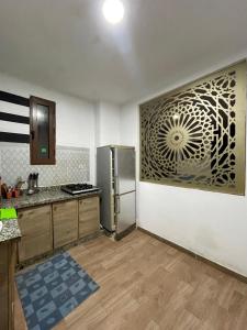 a kitchen with a stainless steel refrigerator in a room at Coin Du Repôs in Oujda