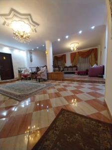 a large living room with a checkerboard floor at Eagles Pyramids View in Cairo