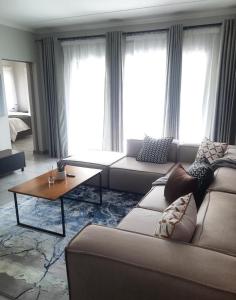 a living room with a couch and a coffee table at 15 Elizabeth Place - Luxury Apartments, Free Wi-Fi in Midrand
