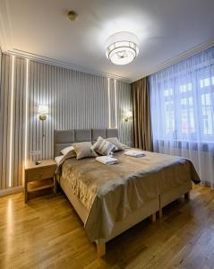 een slaapkamer met een groot bed en een groot raam bij Villa Neve in Ustrzyki Dolne
