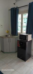 a kitchen with a sink and a microwave on a counter at Kaya Lethu in Maputo