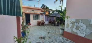 une cour d'une maison avec une table et des chaises dans l'établissement Kaya Lethu, à Maputo