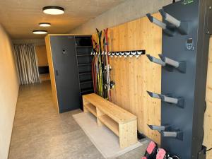 a room with skis on a wall and a bench at Luis Chalet in Brunico