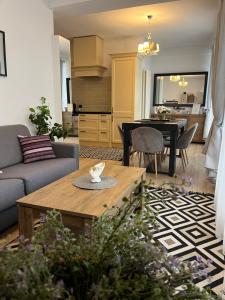 a living room with a table and a dining room at Roman House Borsa in Borşa +33 photos