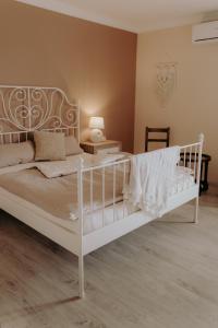 a bedroom with a white bed and a table at Villa Soluna in Vélez-Málaga
