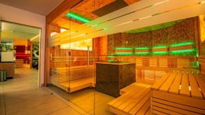 a restaurant with a bar with green lights at Vital- und Wellnesshotel Albblick in Waldachtal